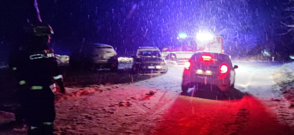 Mezzi bloccati lungo la strada innevata e qualche automobilista cerca (senza successo) di passare per prati e campi