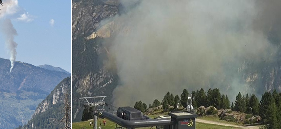 Un'alta colonna di fumo dal bosco visibile da tutta la valle: grosso incendio in montagna